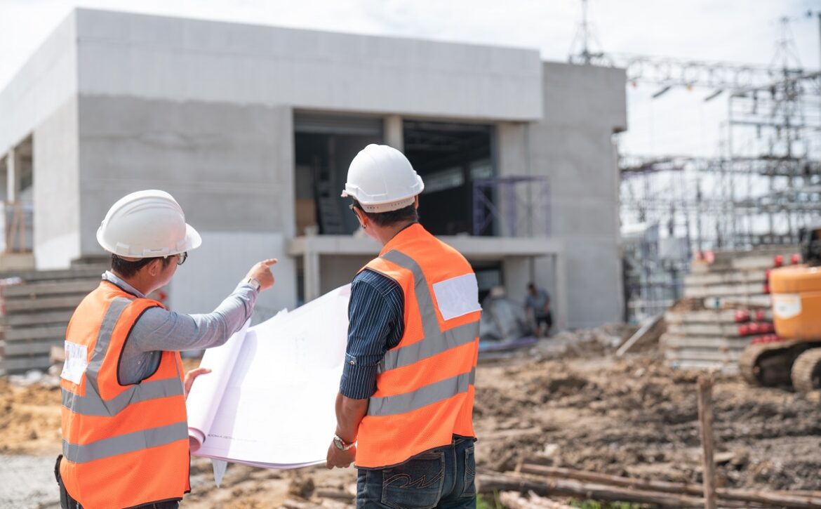 Construction engineers discussion with architects at constructio