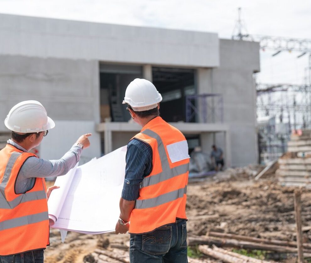 Construction engineers discussion with architects at constructio