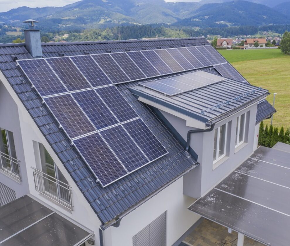 High angle shot of a private house situated in a valley with solar panels on the roof